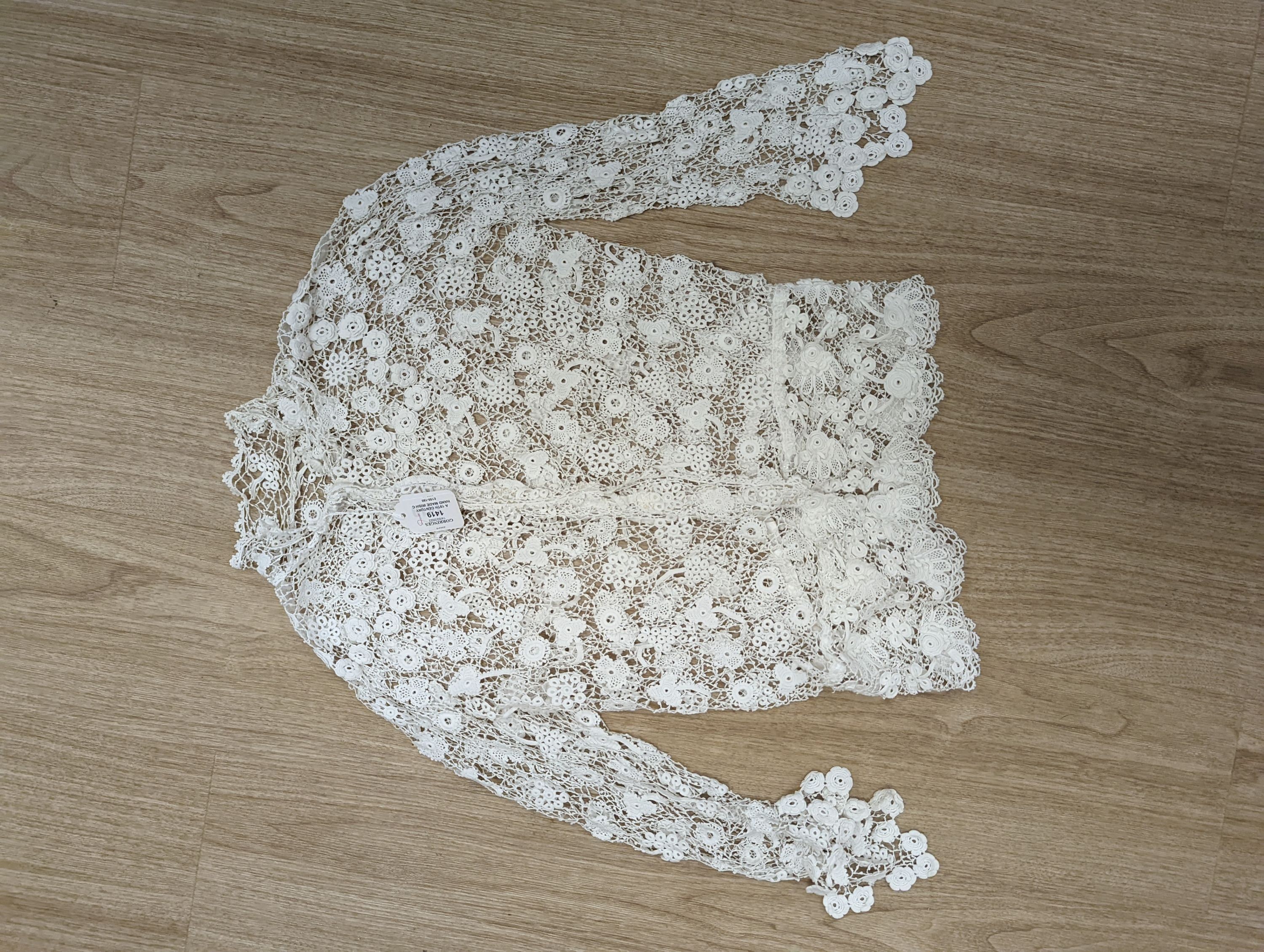 A 19th century hand made Irish crochet jacket, with long sleeves and high collar, a bobbin lace and white worked patch worked blouse, a fine lawn and anglaise worked blouse and a fine bobbin lace trimmed and white worked